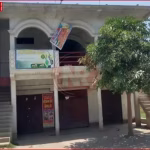 एक अस्पताल के बाहर पुलिस और लोगों की भीड़, जिस पर ताला लगा है।