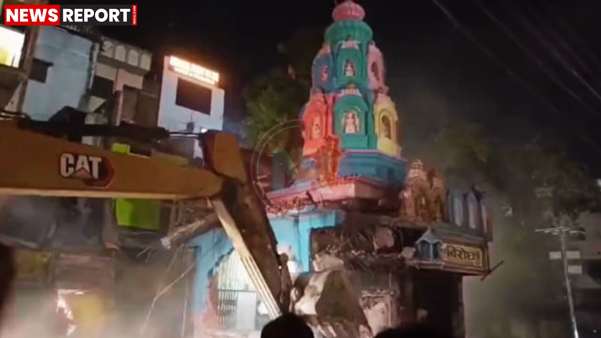 सड़क चौड़ीकरण के दौरान गिरा हुआ मंदिर का गुंबद और मलबा, पास में पुलिस और बचावकर्मी