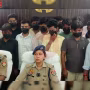 वाराणसी में साइबर ठगी गिरोह के भंडाफोड़ के बाद पुलिस अधिकारी बरामद सामान के साथ
